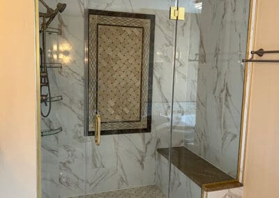 New glass shower doors with gold hardware